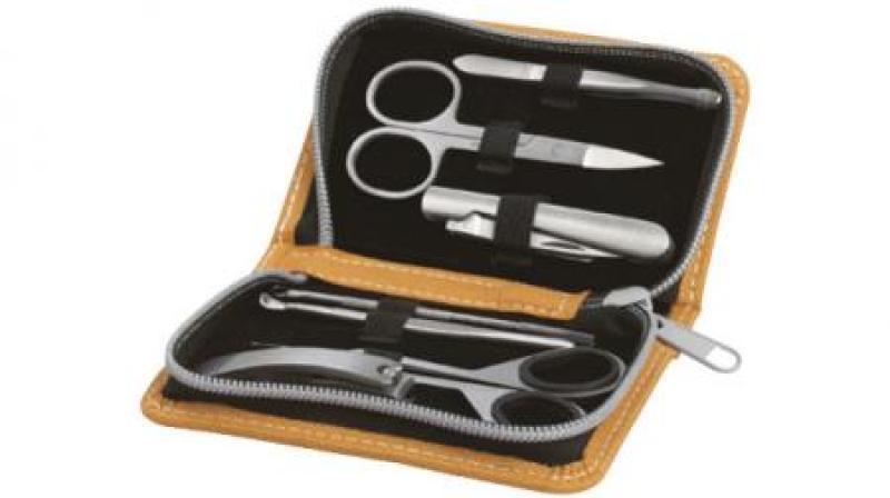 MANICURE SET â€“ 5 piece manicure set in orange case.